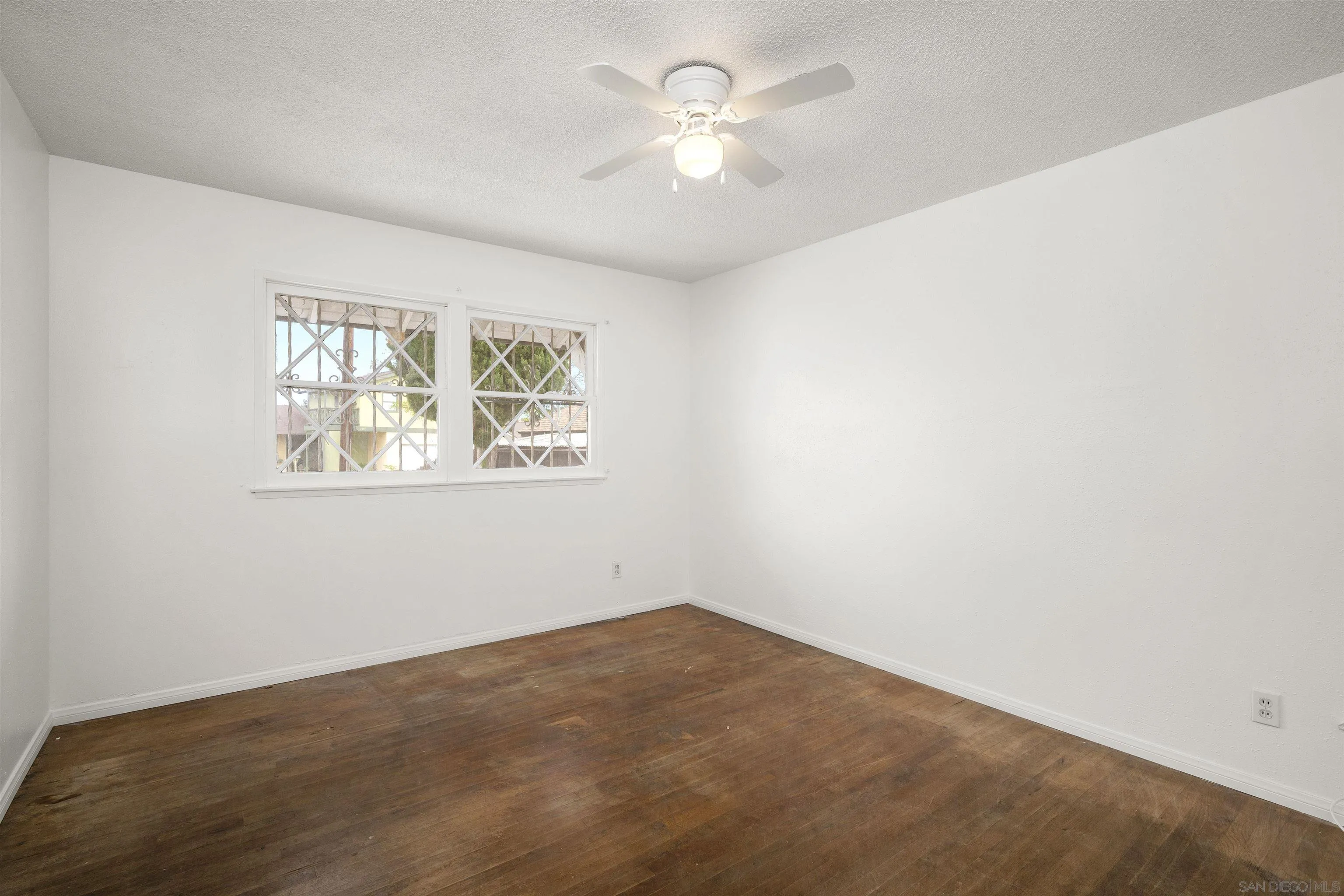 2854 Rhoades Road San Diego, CA 92139 - Photo 9 of 10 an empty room with a window and a ceiling fan