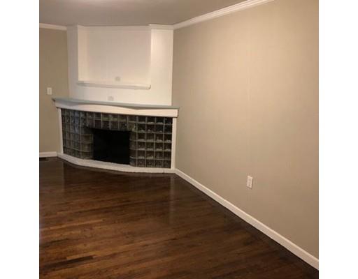 412 South Meadow Road Lancaster, MA 01523 - Photo 12 of 24 a view of an empty room with wooden floor and a fireplace