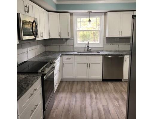 412 South Meadow Road Lancaster, MA 01523 - Photo 3 of 24 a kitchen with granite countertop wooden cabinets appliances a sink and a window