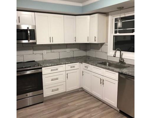 412 South Meadow Road Lancaster, MA 01523 - Photo 4 of 24 a kitchen with granite countertop white cabinets and appliances