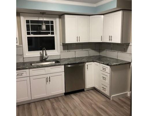 412 South Meadow Road Lancaster, MA 01523 - Photo 5 of 24 a kitchen with granite countertop white cabinets and white appliances