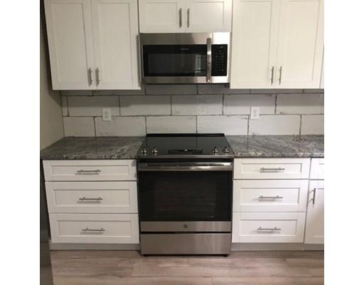 412 South Meadow Road Lancaster, MA 01523 - Photo 6 of 24 a kitchen with granite countertop white cabinets and stainless steel appliances