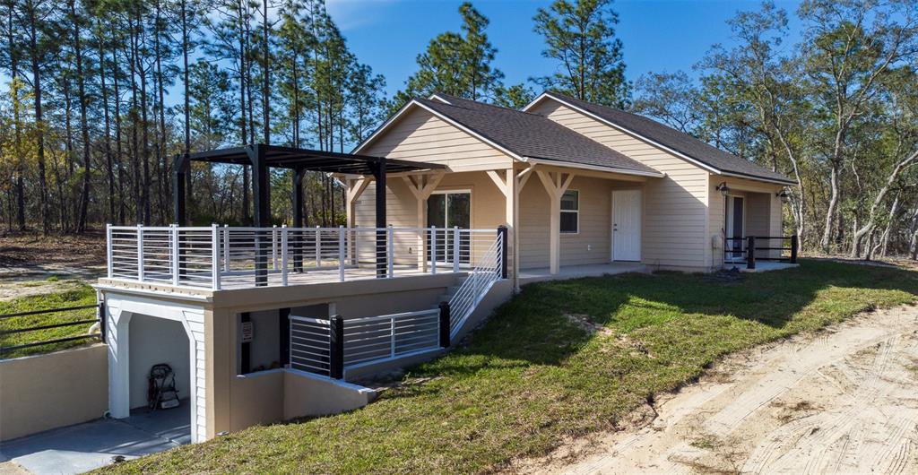 12293 Southwest 89th Street Dunnellon, FL 34432 - Photo 1 of 21 a front view of a house with garden