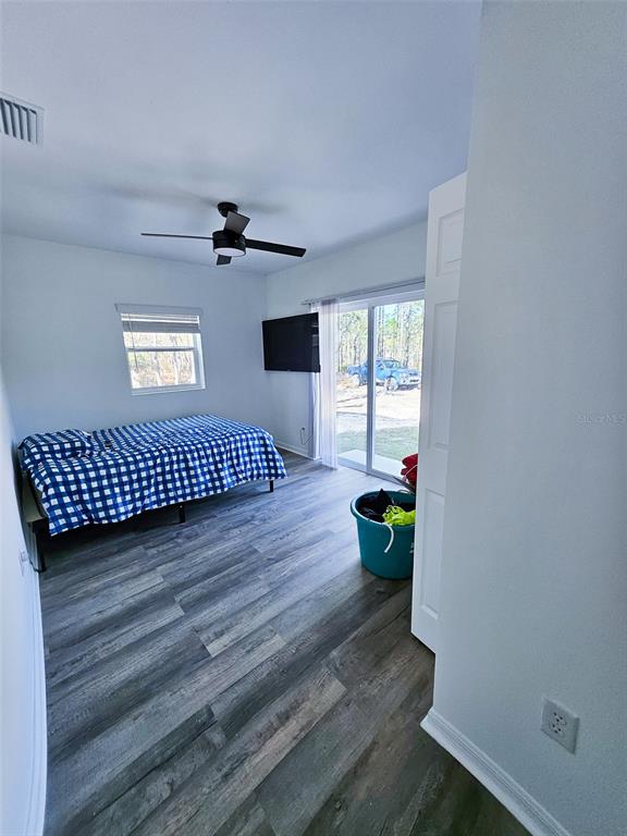 12293 Southwest 89th Street Dunnellon, FL 34432 - Photo 18 of 21 a view of a hardwood floor and a ceiling fan in wooden floor