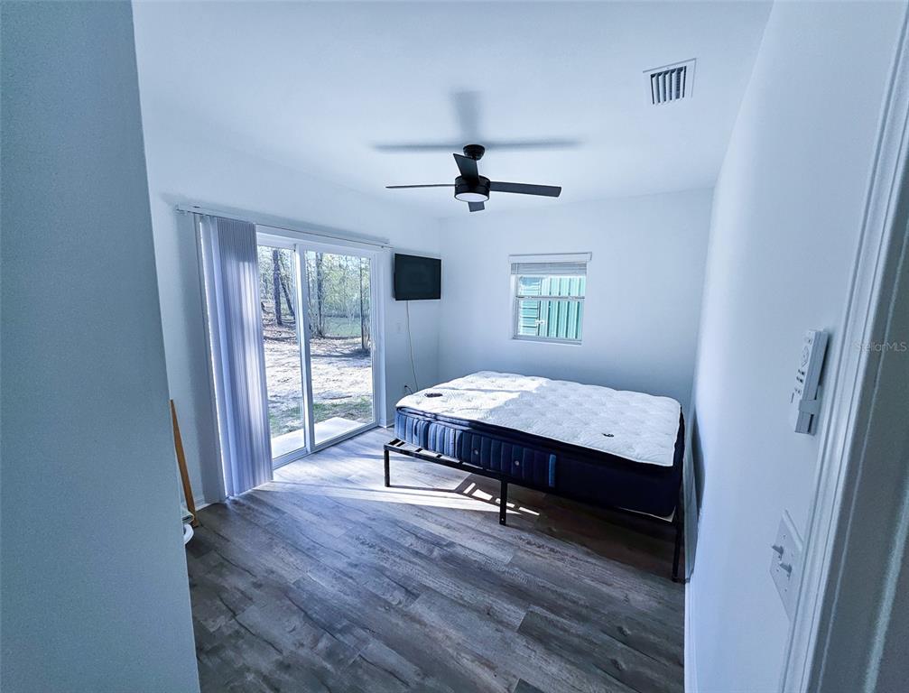 12293 Southwest 89th Street Dunnellon, FL 34432 - Photo 20 of 21 a spacious bedroom with a bed and a window
