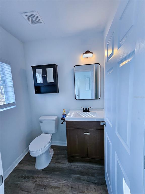 12293 Southwest 89th Street Dunnellon, FL 34432 - Photo 21 of 21 a bathroom with a toilet sink and mirror