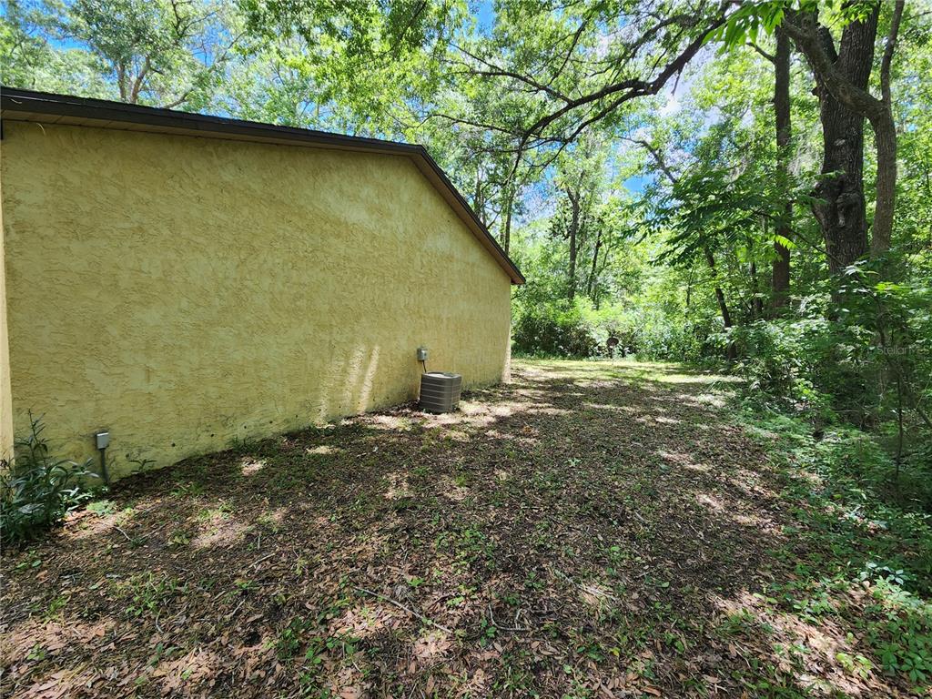 4021 Southwest 37 Street, Unit C Gainesville, FL 32608 - Photo 2 of 25 a backyard of a house with lots of green space