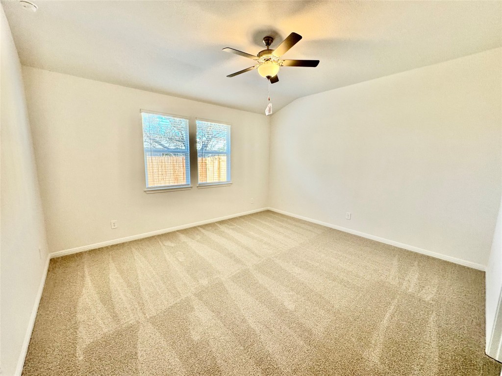 1788 South Main Street Kyle, TX 78640 - Photo 3 of 7 Unfurnished room with carpet floors, a ceiling fan, and lofted ceiling