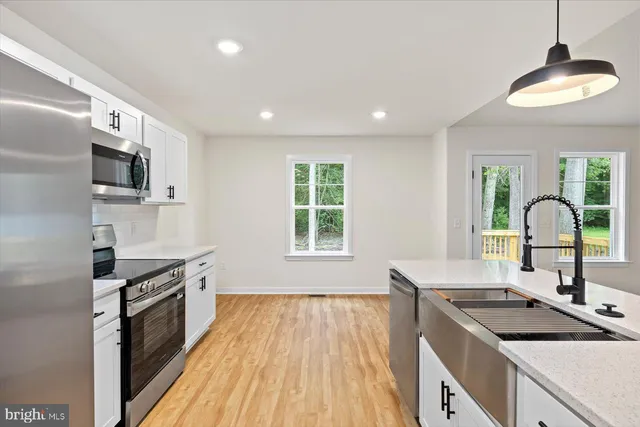 a kitchen with a sink stove and refrigerator