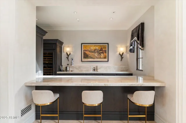 a living room with furniture a chandelier and a large window