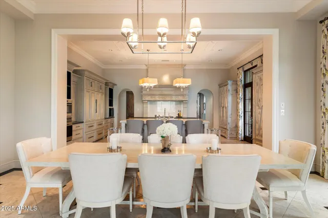 a dining room with furniture and a floor to ceiling window