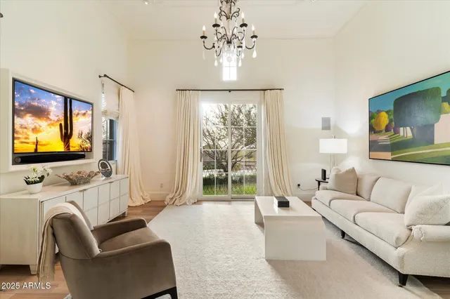 a bedroom with a large bed and a couch next to a window