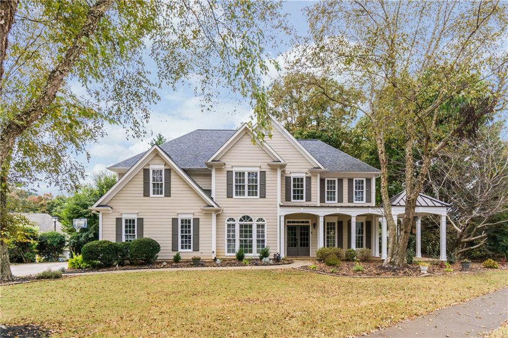 6710 Timber Cove Cumming, GA 30041 - Photo 1 of 42 a front view of a house with a yard