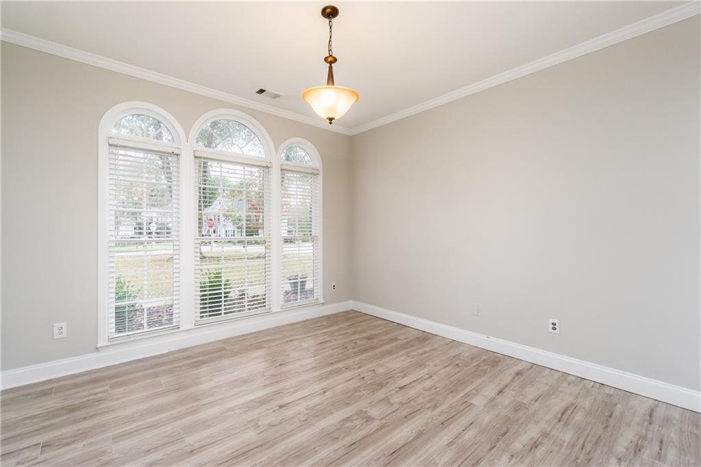 6710 Timber Cove Cumming, GA 30041 - Photo 14 of 42 an empty room with wooden floor and windows