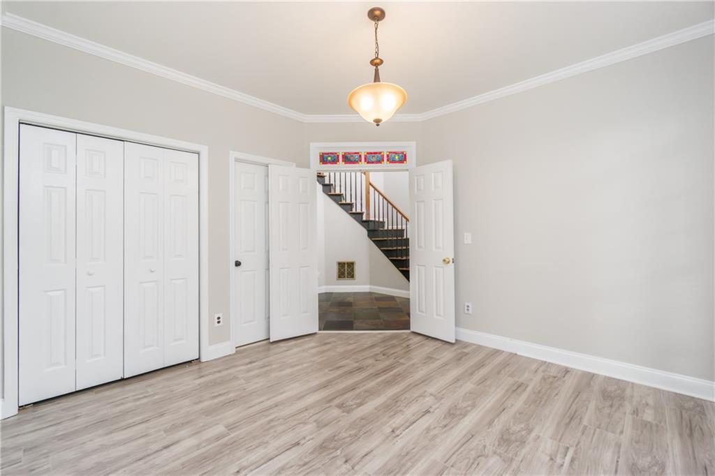6710 Timber Cove Cumming, GA 30041 - Photo 15 of 42 a view of a hallway with wooden floor and staircase