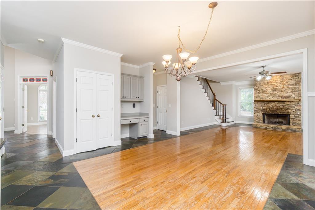 6710 Timber Cove Cumming, GA 30041 - Photo 17 of 42 a view of a livingroom with a fireplace a chandelier and wooden floor