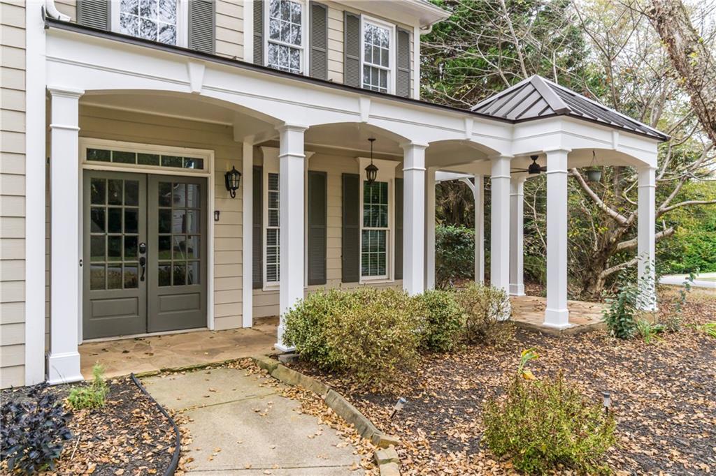 6710 Timber Cove Cumming, GA 30041 - Photo 2 of 42 front view of a brick house with a large window