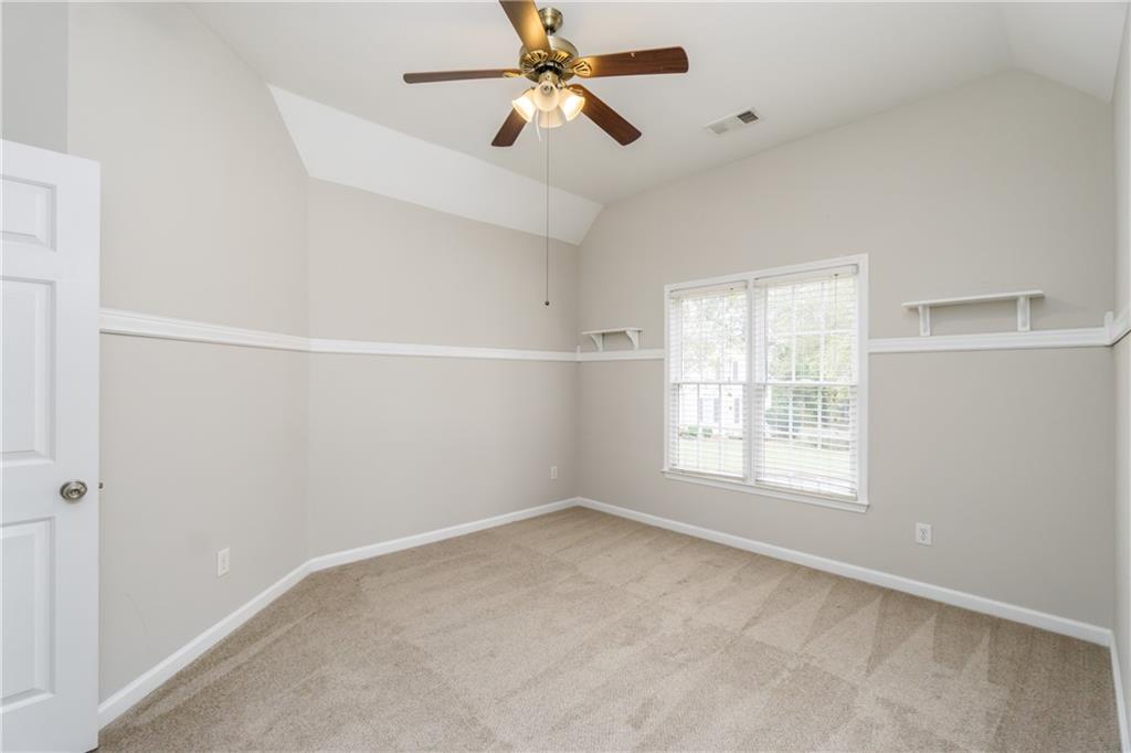 6710 Timber Cove Cumming, GA 30041 - Photo 26 of 42 an empty room with windows and fan