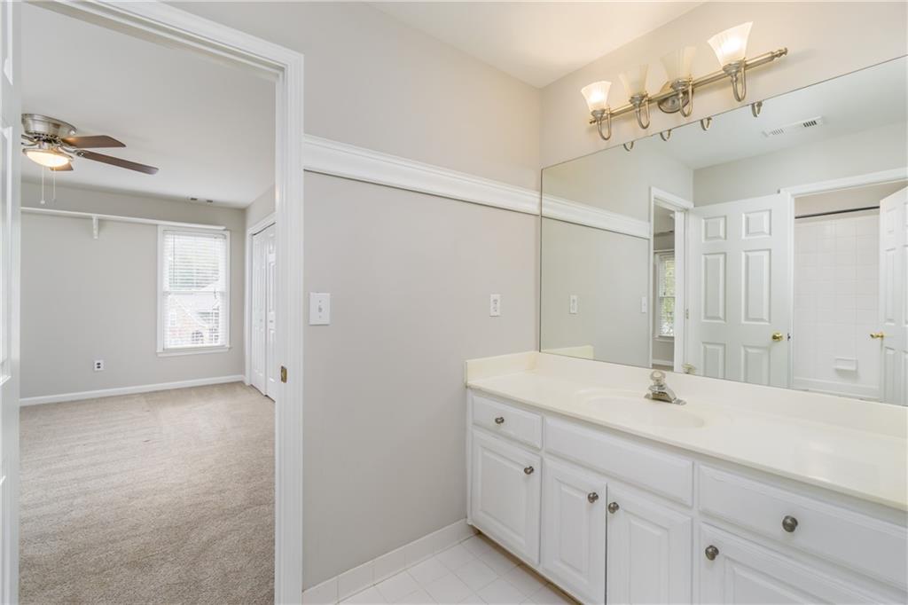 6710 Timber Cove Cumming, GA 30041 - Photo 28 of 42 a bathroom with a sink a light fixture and a mirror