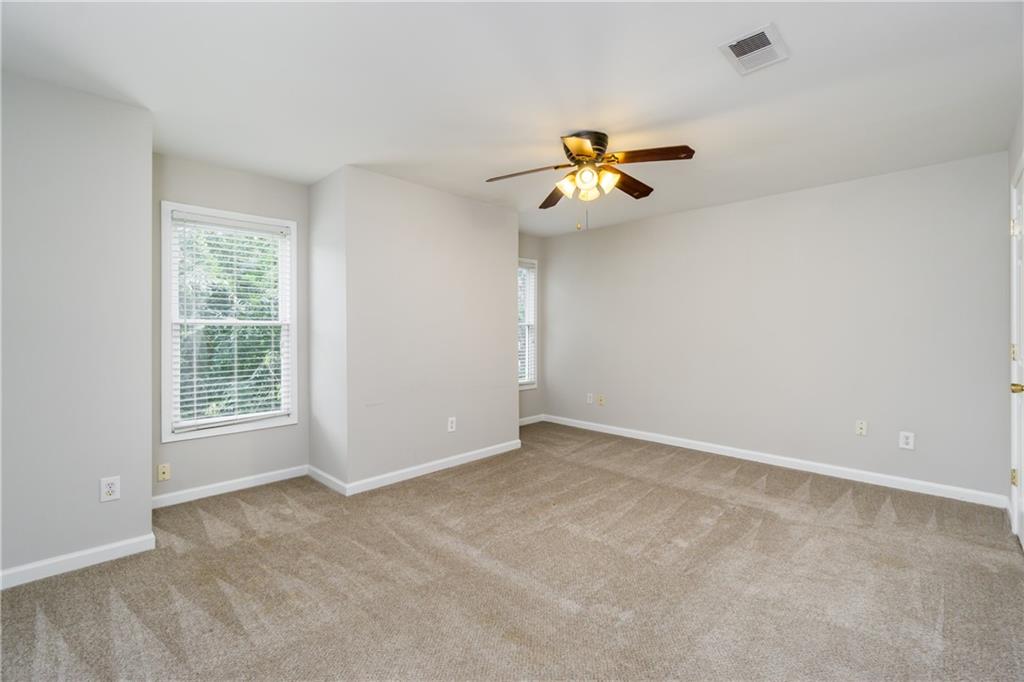 6710 Timber Cove Cumming, GA 30041 - Photo 30 of 42 a view of room with a ceiling fan and window