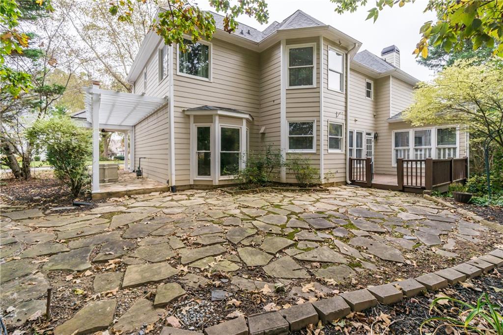 6710 Timber Cove Cumming, GA 30041 - Photo 33 of 42 a front view of a house with a garden