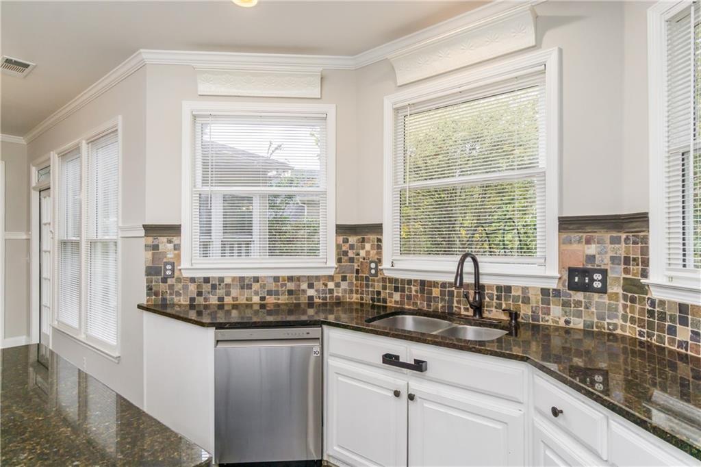 6710 Timber Cove Cumming, GA 30041 - Photo 8 of 42 a kitchen with granite countertop a sink and a window