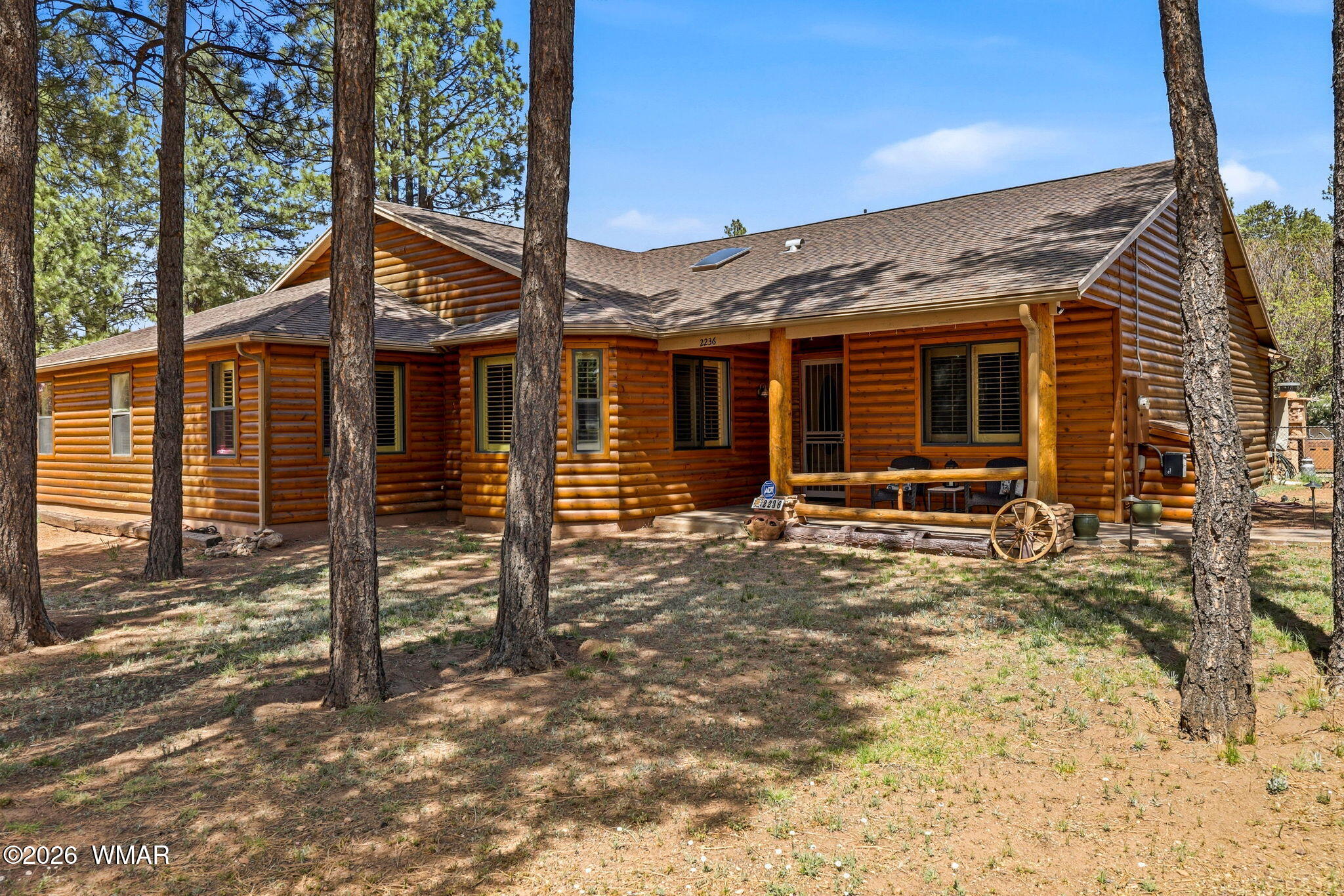 a view of a house with backyard porch and wooden fence