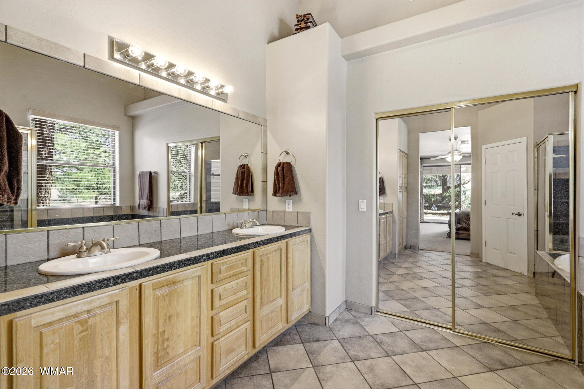 2236 Roundabout Way Overgaard, AZ 85933 - Photo 16 of 45 a spacious bathroom with a granite countertop sink a mirror and a shower