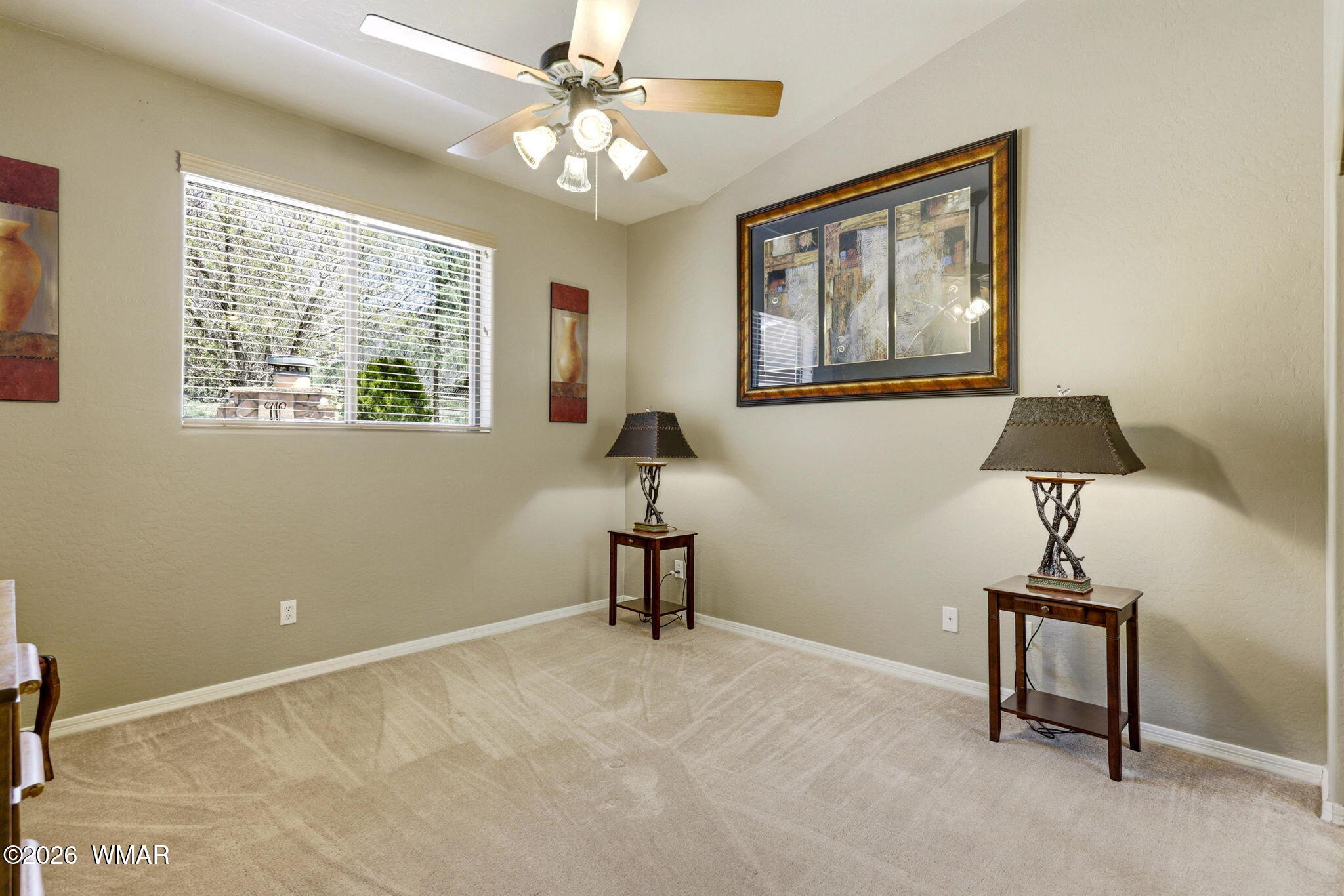 2236 Roundabout Way Overgaard, AZ 85933 - Photo 19 of 45 a bedroom with a bed and a chandelier