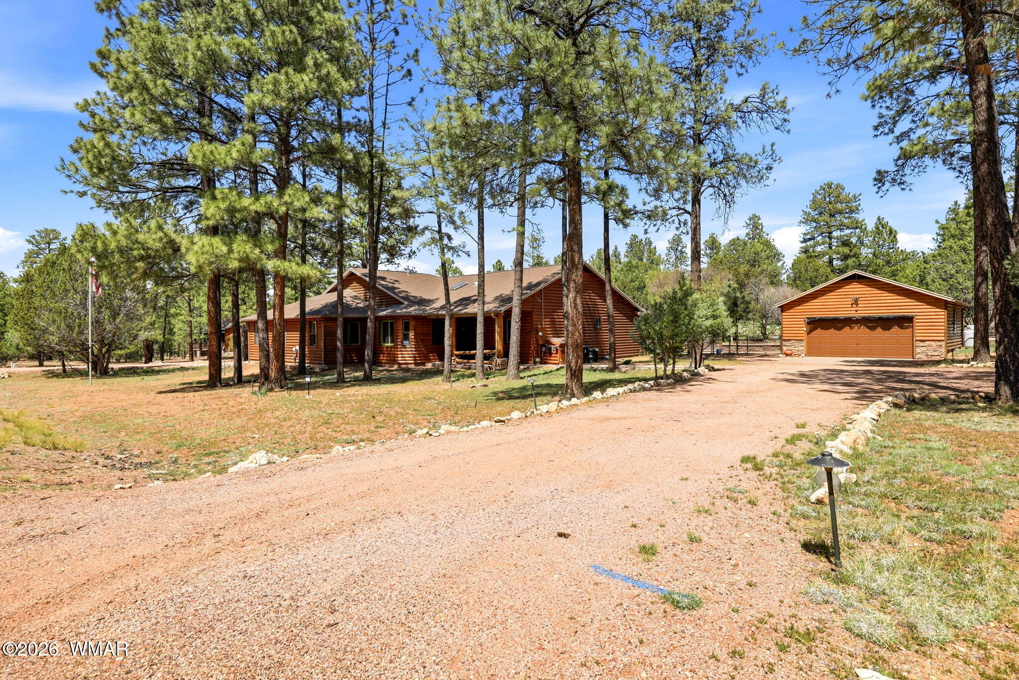 2236 Roundabout Way Overgaard, AZ 85933 - Photo 40 of 45 a view of swimming pool with large trees and wooden fence