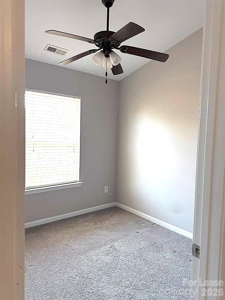 2716 Dunrobin Place Fort Mill, SC 29707 - Photo 20 of 26 an empty room with a window and a fan