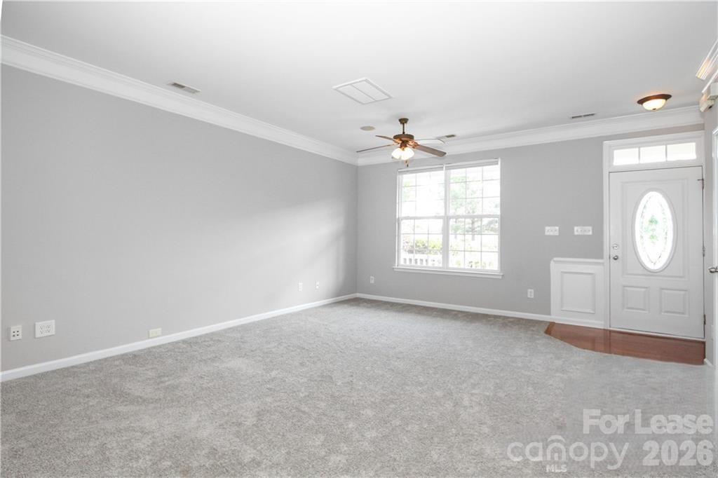 2716 Dunrobin Place Fort Mill, SC 29707 - Photo 5 of 26 an empty room with windows and fan