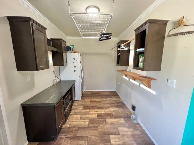 a hallway with stainless steel appliances a refrigerator and a stove