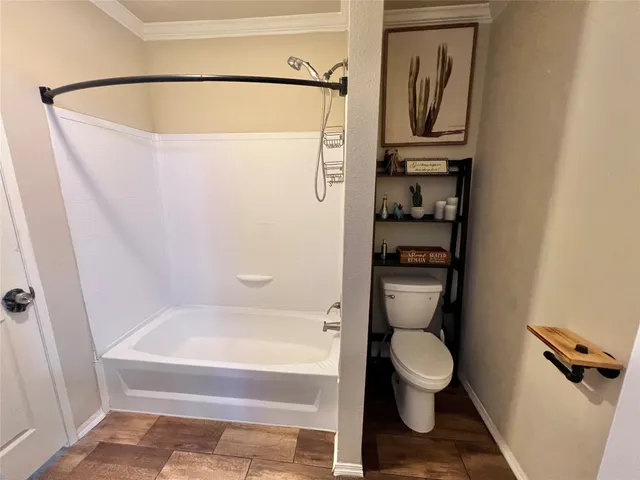 a bathroom with a toilet and a shower