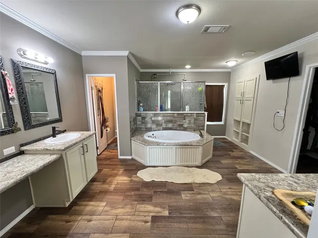 a spacious bathroom with a double vanity sink a mirror and a bathtub