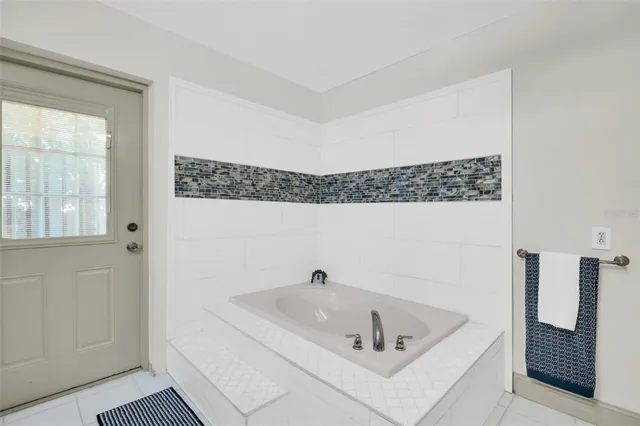 a bathroom with a tub and shower