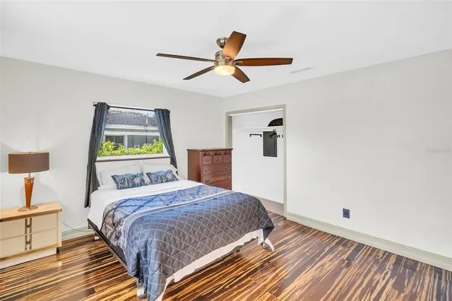 a bedroom with a bed and wooden floor