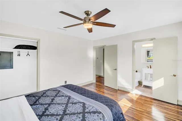 a bedroom with a bed and a large mirror