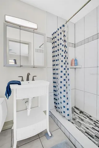 a bathroom with a sink toilet and shower