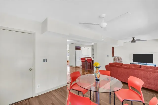a view of a dining room with furniture and wooden floor