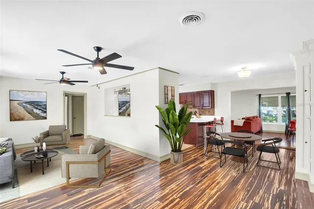 a living room with furniture and wooden floor