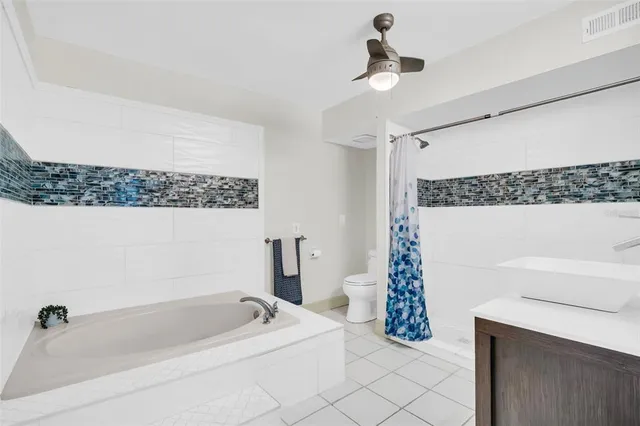 a bathroom with a bathtub a shower and a sink