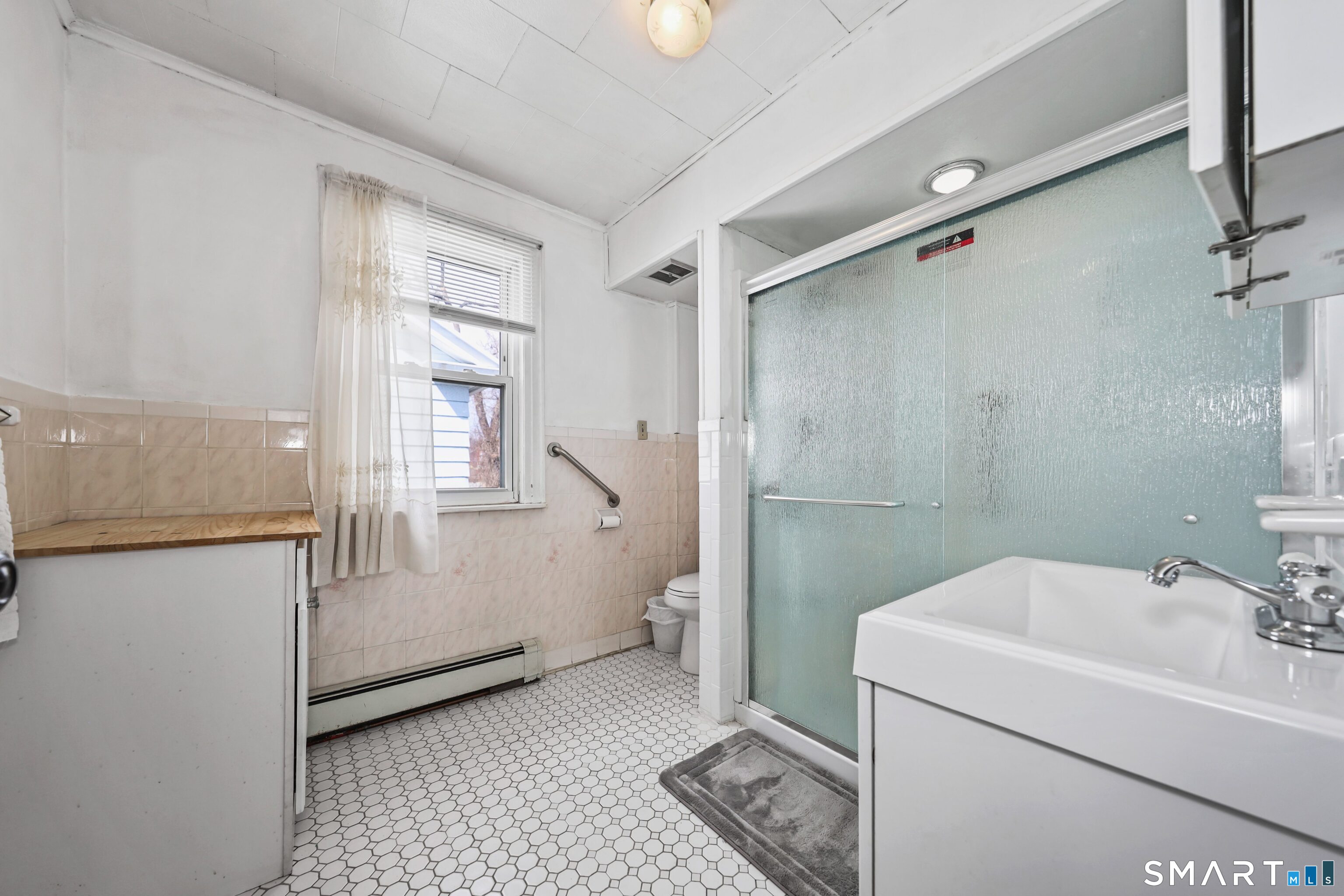 33 West View Street Waterbury, CT 06706 - Photo 18 of 29 a bathroom with a sink toilet and shower