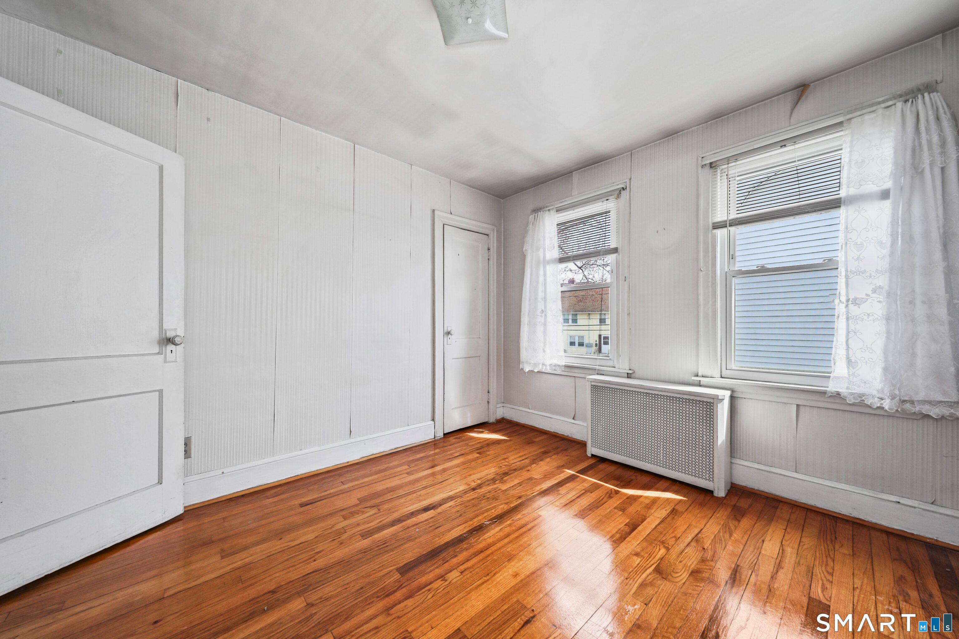 33 West View Street Waterbury, CT 06706 - Photo 22 of 29 a view of an empty room with window and wooden floor