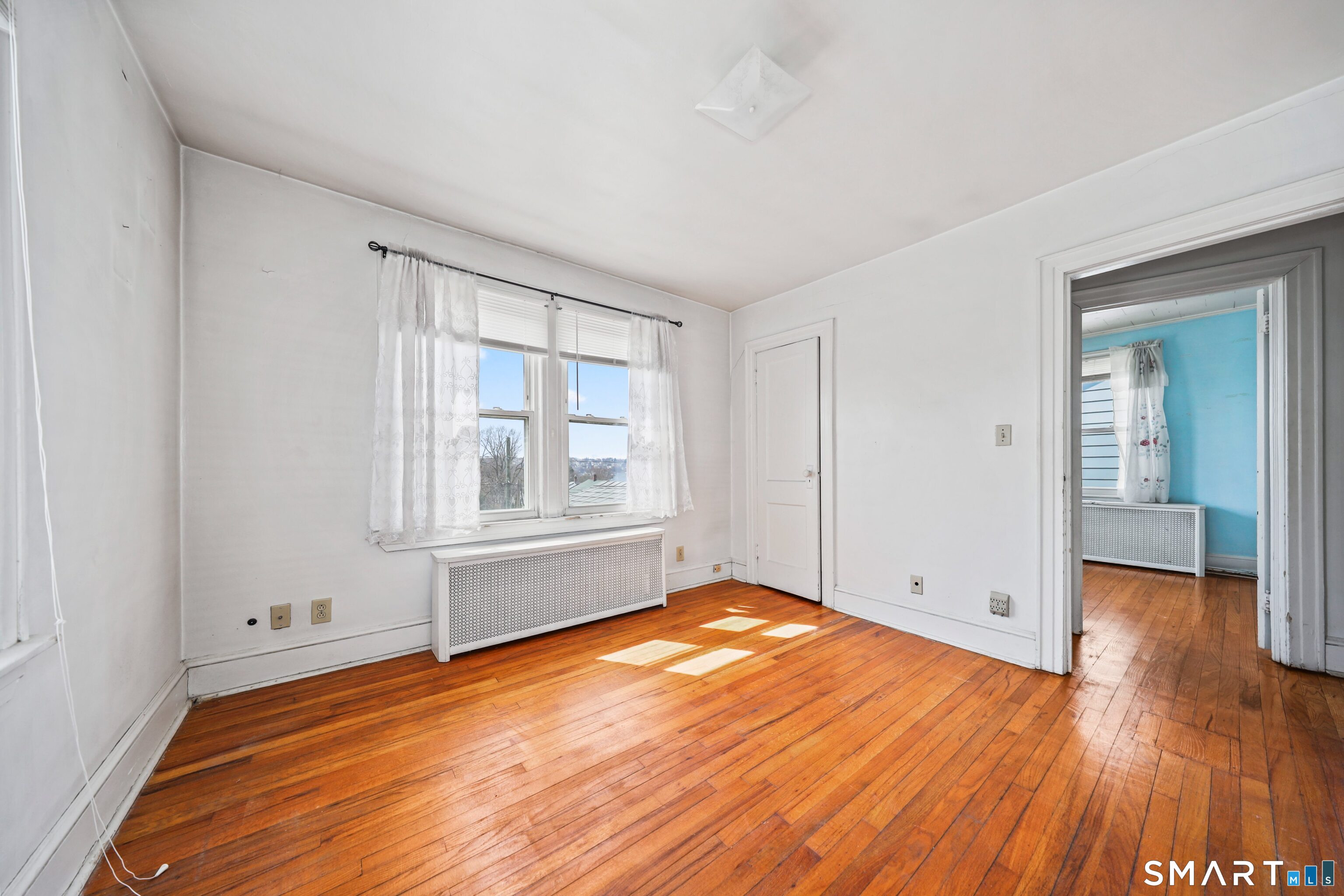 33 West View Street Waterbury, CT 06706 - Photo 23 of 29 a view of empty room with wooden floor and fan