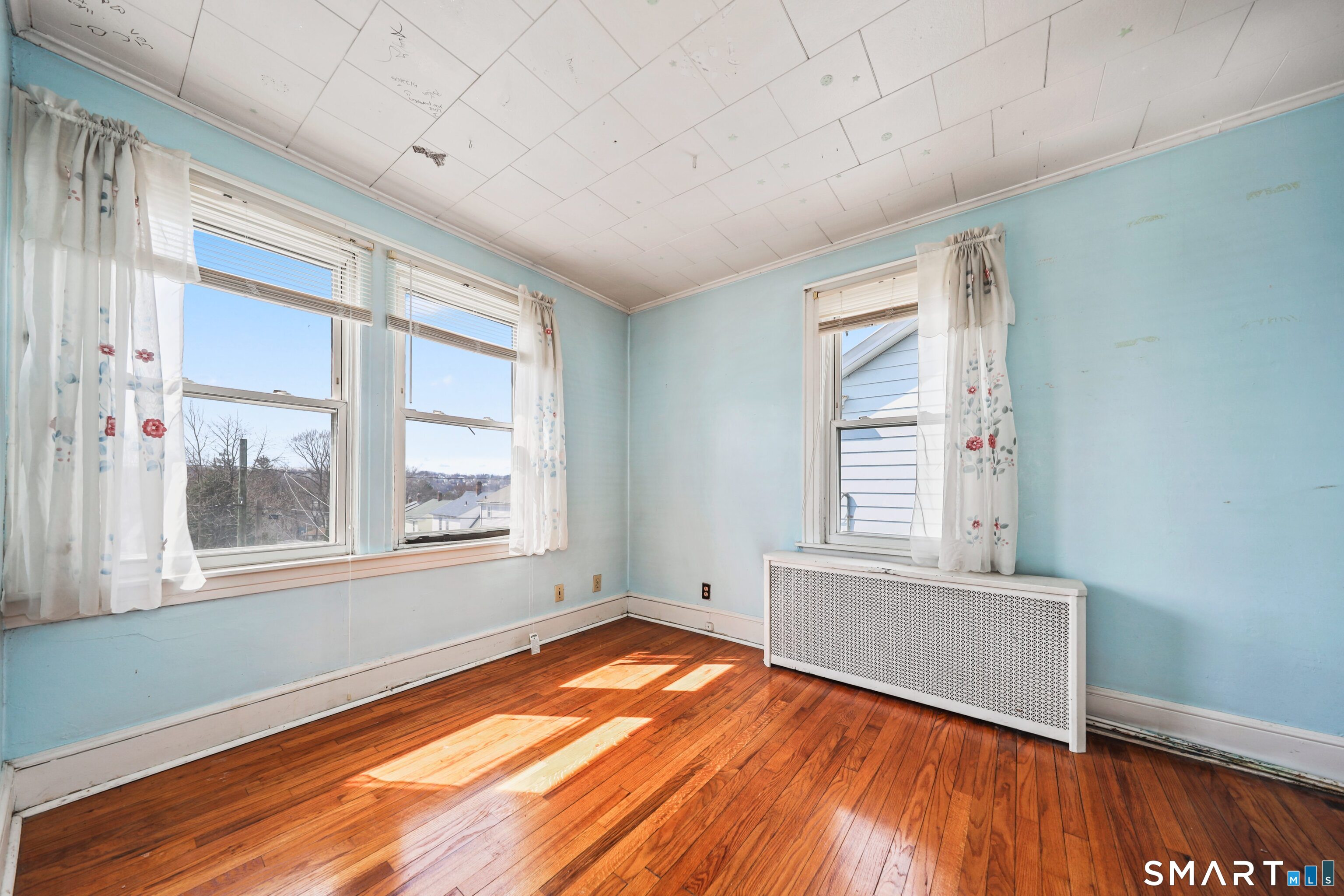 33 West View Street Waterbury, CT 06706 - Photo 25 of 29 an empty room with wooden floor and windows