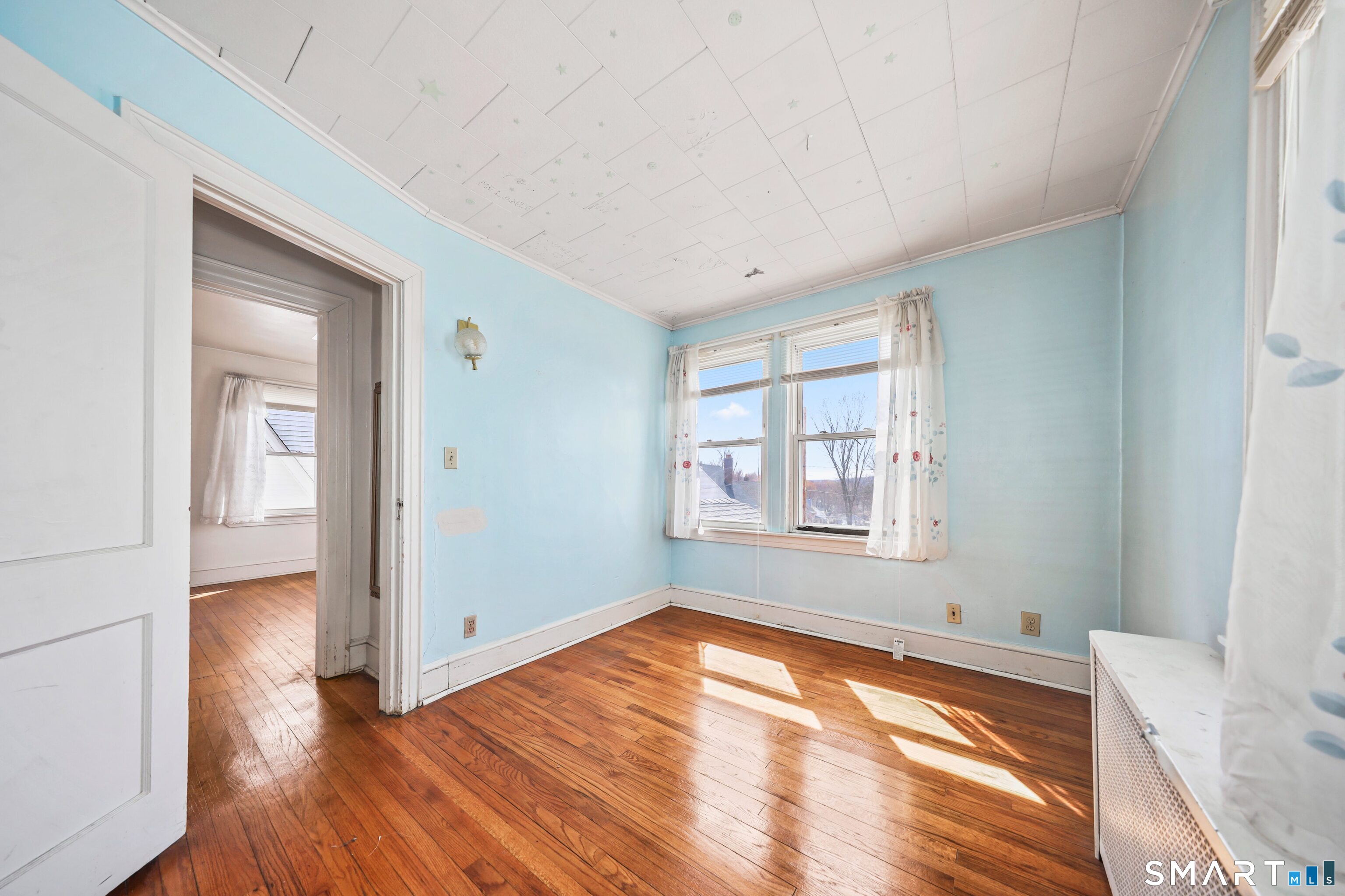 33 West View Street Waterbury, CT 06706 - Photo 26 of 29 an empty room with wooden floor and windows