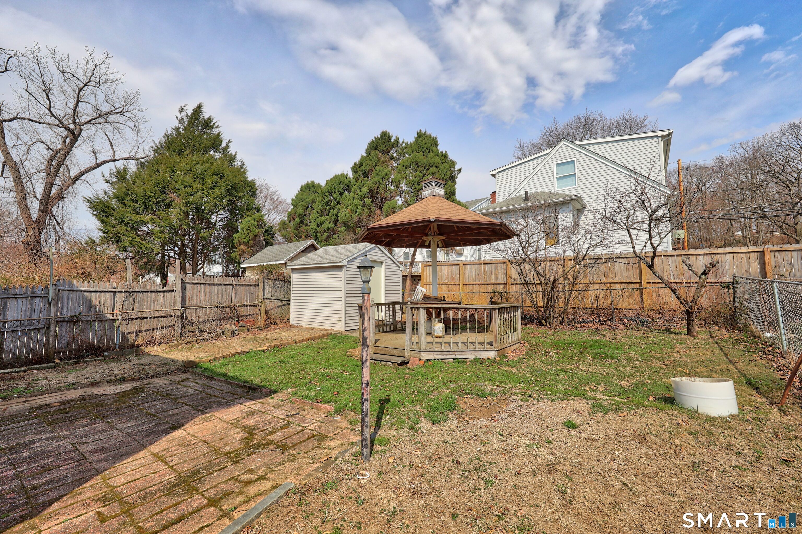 33 West View Street Waterbury, CT 06706 - Photo 28 of 29 a patio with a table and chairs under an umbrella