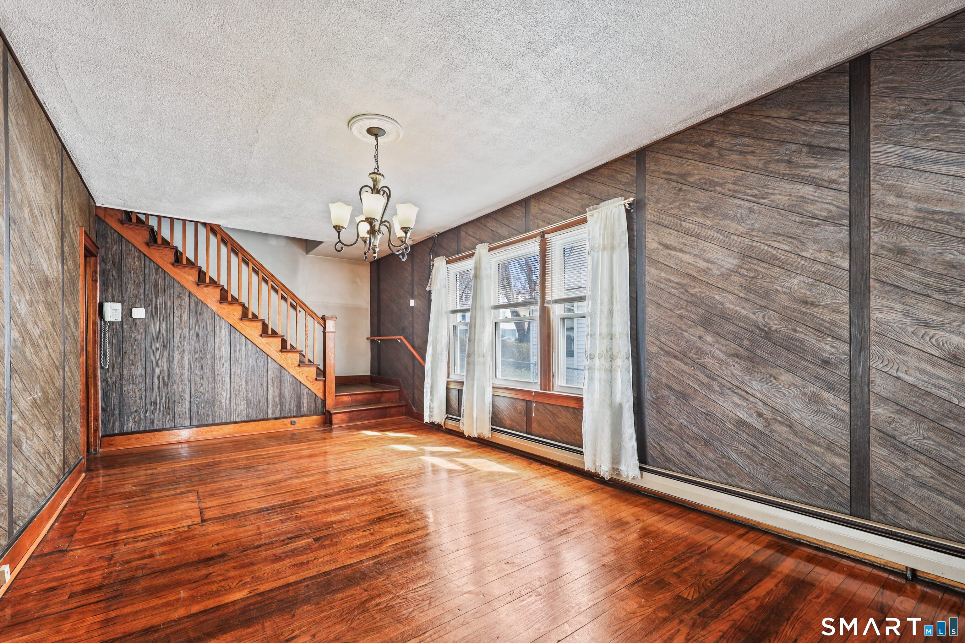 33 West View Street Waterbury, CT 06706 - Photo 3 of 29 a view of a room with wooden floor chandelier and windows