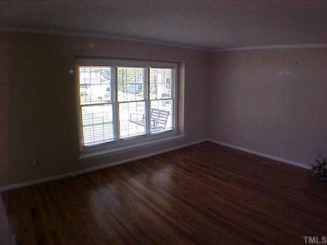 2320 Declaration Drive Raleigh, NC 27615 - Photo 2 of 10 a view of an empty room with wooden floor and a window